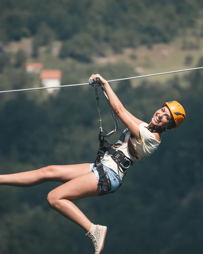 Rider crossing a valley on a zipline